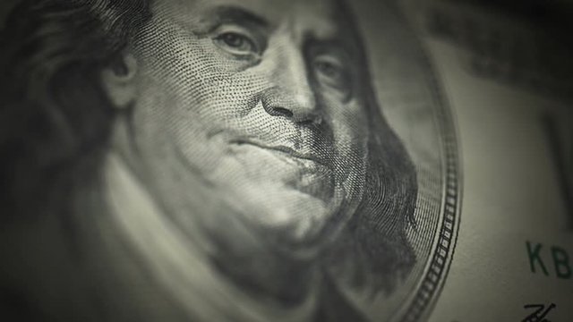 Hundred Dollar Bill, Franklin (25fps). Camera moves down the portrait of Benjamin Franklin on an uncut crisp sheet of U.S. $100 bills, freshly minted from a printing press.