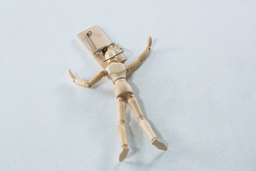 Wooden figurine caught in the mouse trap