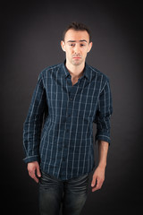 Obraz premium Handsome man doing different expressions in different sets of clothes: surprise