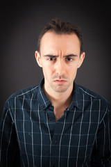 Fototapeta premium Handsome man doing different expressions in different sets of clothes: angry