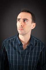 Fototapeta premium Handsome man doing different expressions in different sets of clothes: thinking