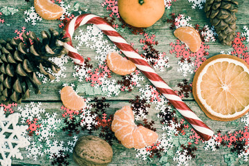 Winter composition with lollipop, slice of dried orange, pine co