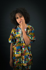 Handsome boy doing different expressions in different sets of clothes: toothache