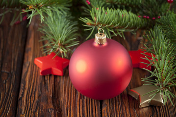 Red Christmas ball on wooden table