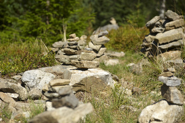 Naklejka na ściany i meble Harmony and balance, poise stones against the forest in the mountains, rock zen sculpture, sunny day