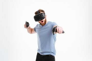 Surprised bearded man wearing virtual reality device