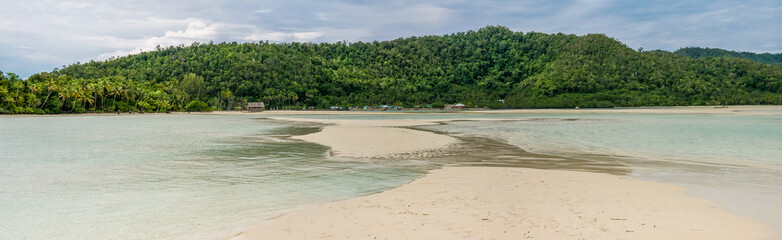 Sandy Bank in front of Local Village on Monsuar Island. Raja Ampat, Indonesia, West Papua