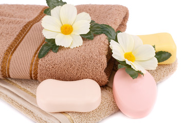 Fototapeta na wymiar Towel, soaps and flowers