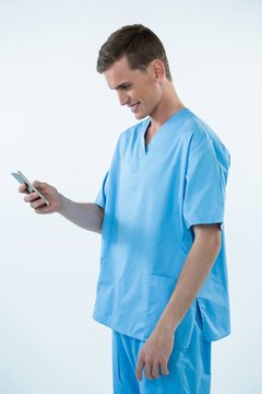 Smiling Male Nurse Using Mobile Phone