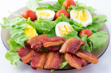 Shredded lettuce, cherry tomatoes, bacon and boiled eggs