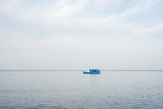 Fototapeta Blue ship sails on the sea