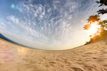 Fototapeta na wymiar Sunny beach wide angle panoramic view blue sky and sea 