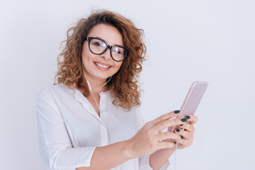 Fototapeta premium Woman in shirt listening to music on phone