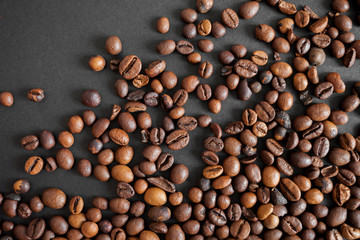 roasted coffee beans over black paper background