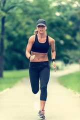 Jogging outdoors. Female athlete jogging outdoors