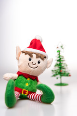 Little elf handmade toy christmas decoration with christmas tree on white background