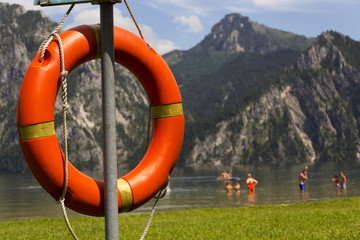 Red lifebuoy hang by mountain lake Traunsee, Salzkammergut Upper Austria