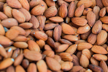 close up brown organic almonds nuts is healthy natural food