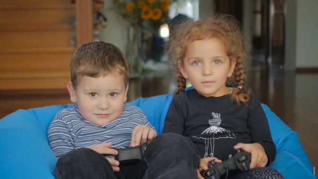 Cute children playing a game on the x-box