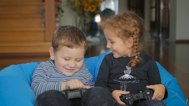 Little children playing a game on the console