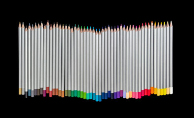 Set of colored pencils on a dark background