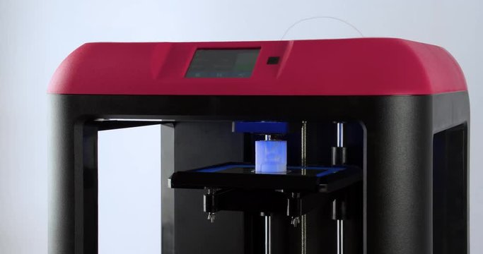 Working 3D printer isolated on white background 4k video. Process of printing three dimensional model: extruder creates object. Additive manufacturing device machine technology concept