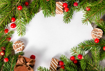 Fototapeta na wymiar Frame with christmas tree, holly and chocolate candies