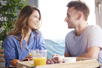 Joyful scene of couple having breakfast