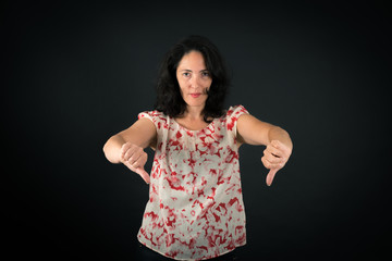 Fototapeta premium Beautiful woman doing different expressions in different sets of clothes: thumbs down