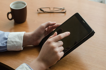 Female hands and a tablet