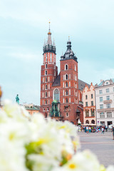 Obraz premium Church of St. Mary in the main Market Square on the background of dramatic sky. Basilica Mariacka. Krakow. Poland.