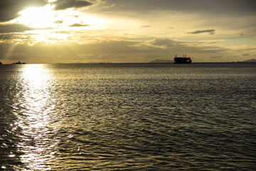 Naklejka na ściany i meble the silhouette of boat in the sea with dramatic tone