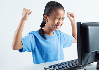 Joyful girl with a computer