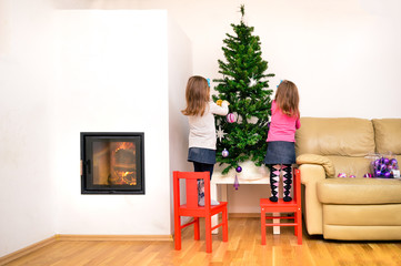 Children and Christmas tree in modern luxury apartment with fire