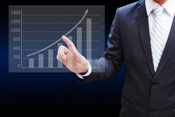 Businessman hand touching the virtual panel of bar chart , busin
