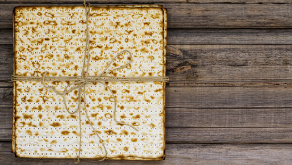 Stack of matzah or matza on a vintage wood background presented