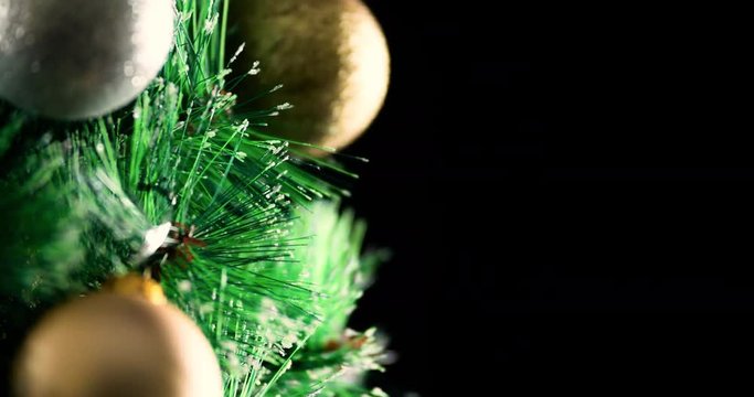Decorated Christmas tree with baubles rotation 4k extreme close-up looped video background with copy space. Merry Christmas and Happy New year greeting card template