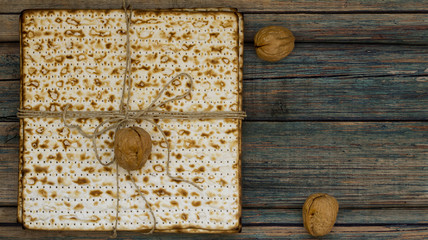 Stack of matzah or matza on a vintage wood background presented