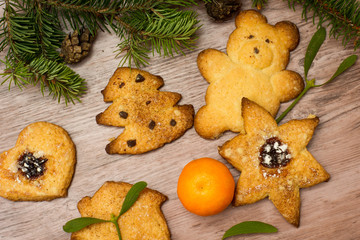 grandma's special christmas cookies among mistletoe, mandarin and christmas tree branches