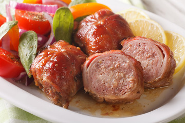 Roasted rabbit fillet with a salad of fresh vegetables close-up. horizontal