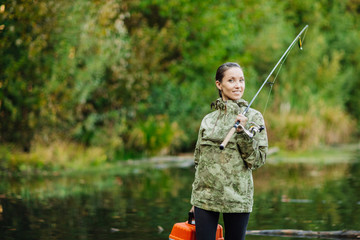pretty woman fishes on the river
