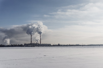 Power station with pipes of which poured smoke on a froze