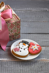 Handmade gift box and homemade gingerbreads on a plate on