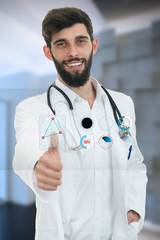 friendly male doctor showing thumbs up in hospital