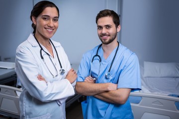Fototapeta premium Portrait of male nurse and doctor standing in ward