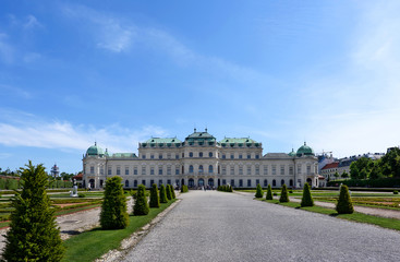 Fototapeta na wymiar Photo back view on upper belvedere palace and garden with statue and flowers, vienna, austria