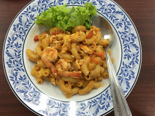 Fried Shrimp macaroni with tomato sauce on the dish, European food 