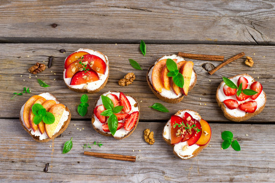 Summer colorful bruschetta appetizer with fruit, curd cheese and