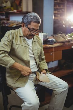Shoemaker repairing a high heel