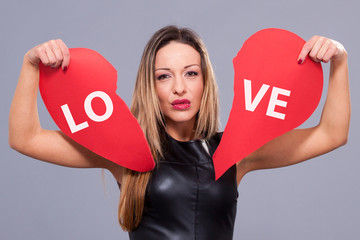 Woman wearing red dress holding big heart sign love symbol